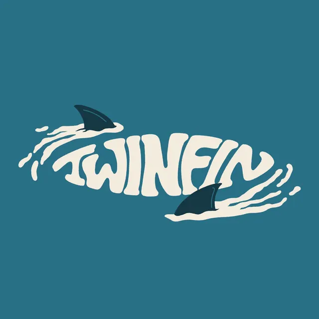 The original TWINFIN logo: the word TWINFIN in cream hand-drawn letters inside a wave splash with two shark fins, on teal